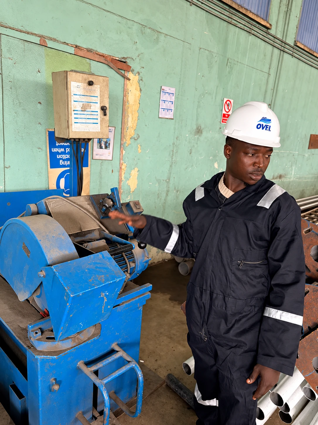 Technical personnel beside industrial equipment at the workshop